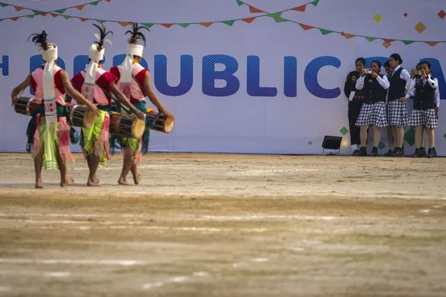 Assam police woman band members take photographs of Tiwa tribals participating in a Republic Day parade in Guwahati, India, Thursday, January 26, 2023. (Photo by Anupam Nath/AP Photo)