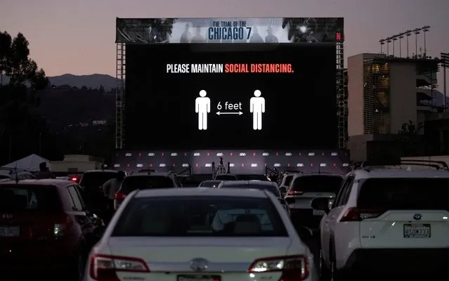 A message reminding about social distancing appears on the screen before a drive-in premiere for the film “The Trial of the Chicago 7” at Rose Bowl in Pasadena, California, U.S., October 13, 2020. (Photo by Mario Anzuoni/Reuters)
