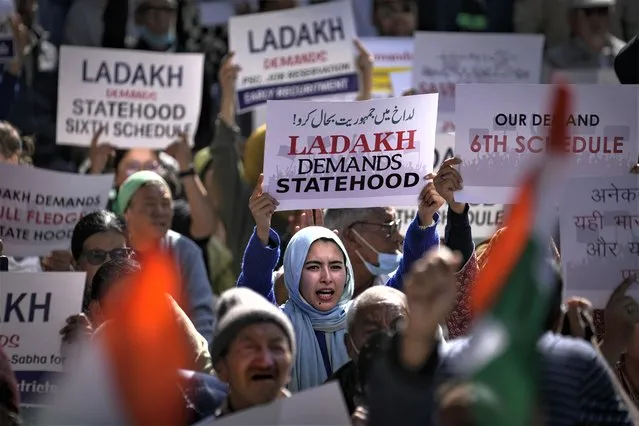 Residents from Ladakh hold placards demanding statehood and other democratic rights for their region during a protest in New Delhi, India, Wednesday, February 15, 2023. Leh Apex Body and Kargil Democratic Alliance, an amalgam of trade unions, social, political and religious groups from Ladakh region held a demonstration Wednesday demanding statehood after Prime Minister Narendra Modi's Hindu nationalist government revoked the special status of Muslim-majority state of Jammu and Kashmir on Aug. 5, 2019 and turned the erstwhile state into two federally administered territories. (Photo by Altaf Qadri/AP Photo)