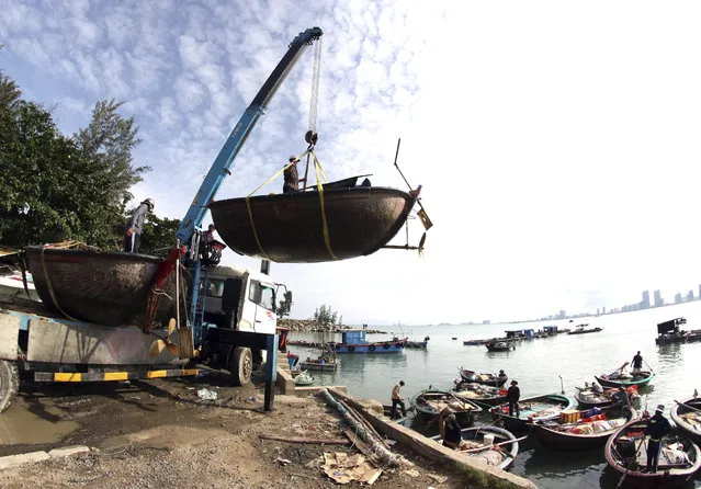 People move fishing boats to save place ahead of Typhoon Molave in Danang, Vietnam on Monday, October 26, 2020. National agency forecasts the typhoon to hit Vietnam on Wednesday morning in the central region where 1.3 people could face evacuation. (Photo by Tran Le Lam/VNA via AP Photo)
