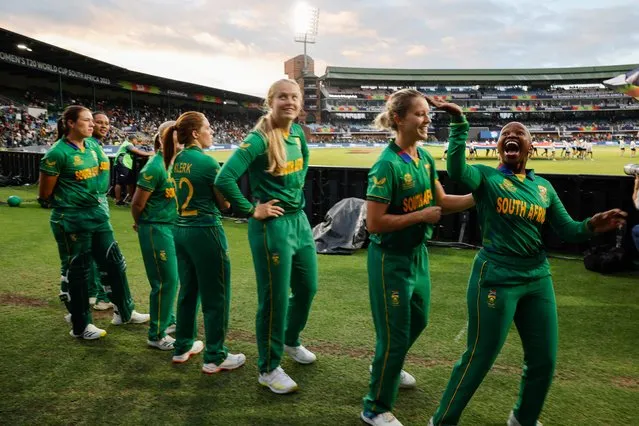 South Africa's Nonkululeko Mlaba (R) wave to supporters ahead of the Group A T20 women's World Cup cricket match between South Africa and Australia at St George's Park in Gqeberha on February 18, 2023. (Photo by Marco Longari/AFP Photo)