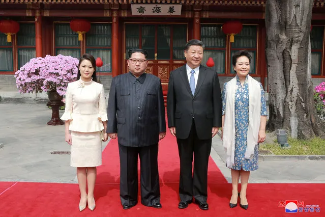 North Korean leader Kim Jong Un and wife Ri Sol Ju, and Chinese President Xi Jinping and wife Peng Liyuan pose for a photo in Beijing on March 28, 2018. (Photo by Reuters/KCNA)