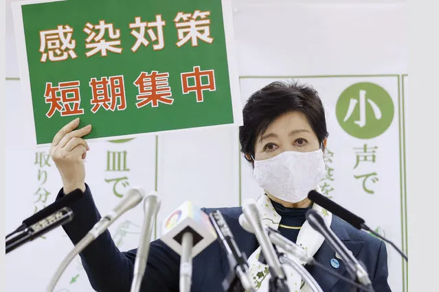 Tokyo Gov. Yuriko Koike speaks during a news conference Wednesday, November 25, 2020, in Tokyo. The board reads “infection control measures, Short and intensive”. (Photo by Kyodo News via AP Photo)