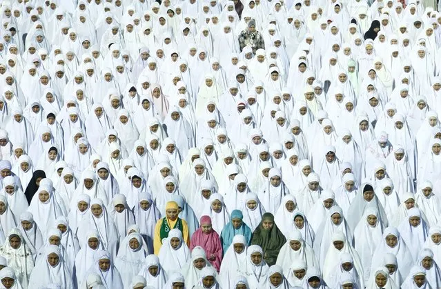 Members of Malaysia's opposition party, Parti Islam Se-Malaysia (PAS), perform a special prayer during a campaign for the upcoming general elections inside a stadium at Kota Bahru early May 3, 2013. Malaysia will hold general elections on May 5 in what could be the toughest test of the ruling coalition's 56-year grip on power in Southeast Asia's third-largest economy. (Photo by Samsul Said/Reuters)