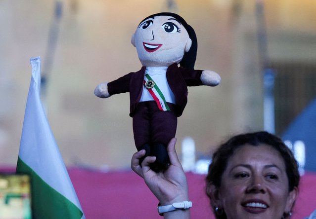 A supporter holds a soft toy representing presidential candidate of the ruling Morena party Claudia Sheinbaum, at the Zocalo plaza in Mexico City, Mexico on June 2, 2024. (Photo by Alexandre Meneghini/Reuters)