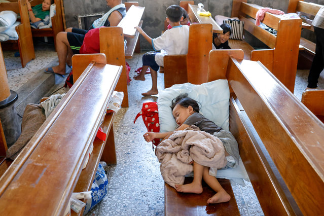 A child sleeps on a bench inside a church that has been turned into a shelter, after flooding brought by Super Typhoon Ragasa, in Hualien, Taiwan, on September 25, 2025. (Photo by Ann Wang/Reuters)
