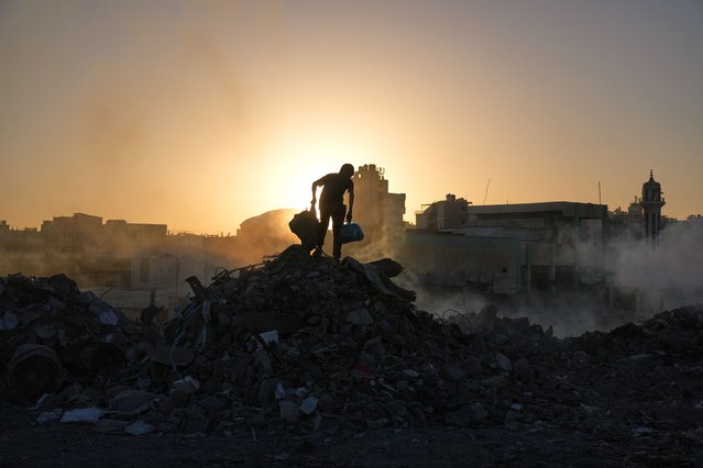 Palestinians search for firewood and plastic at a landfill in Gaza City Saturday, October 25, 2025. (Photo by Abdel Kareem Hana/AP Photo)
