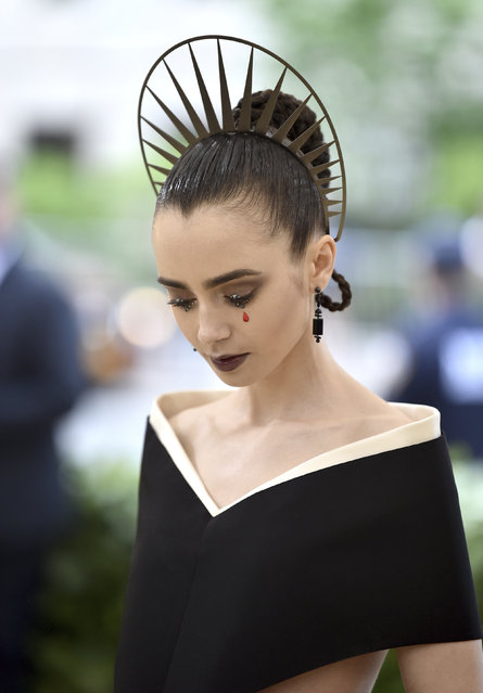 Lily Collins attends The Metropolitan Museum of Art's Costume Institute benefit gala celebrating the opening of the Heavenly Bodies: Fashion and the Catholic Imagination exhibition on Monday, May 7, 2018, in New York. (Photo by Evan Agostini/Invision/AP Photo)