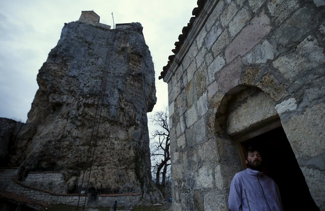 A man attends a service near the church on top of the Katskhi Pillar, a rock mass about 40 meters high, in the village of Katskhi, Georgia, November 27, 2015. (Photo by David Mdzinarishvili/Reuters)