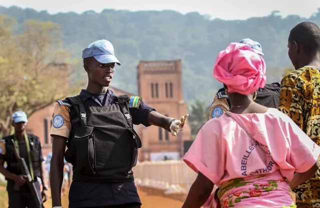 United Nations peacekeepers from Rwanda control and search the faithful before the celebration of mass by Pope Francis at the Cathedral in Bangui, Central African Republic, November 29, 2015. (Photo by Anthony Fouchard/Reuters)
