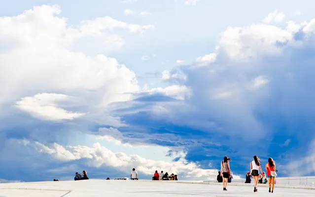 People walk on the roof of the Oslo Opera House, Norway, on June 19, 2013. (Photo by Vegard Grott/AFP Photo)