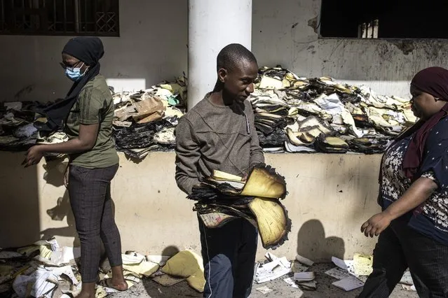 Archival and documentation students sift through burned documents at the Cheikh Anta Diop University in Dakar on June 09, 2023 in an effort to salvage them. Tens of thousands of student archives dating back to 1957 where burned during protest that broke out on June 01, 2023 after opposition leader Ousmane Sonko was sentenced to two years in prison. (Photo by John Wessels/AFP Photo)