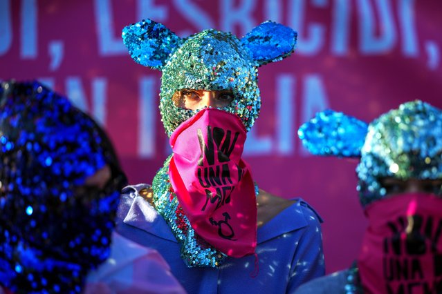 Demonstrators wave scarfs reading “Not one less” as they take part in a rally ahead of the International Day for the Elimination of Violence against Women which will be held on November 25, in Rome, Saturday, Nov. 23, 2024. (Photo by Andrew Medichini/AP Photo)
