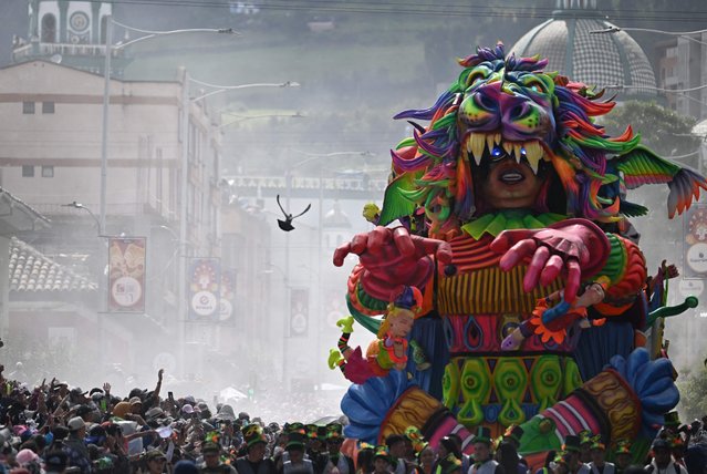 Artistas perform with traditional floats during the “Blacks and Whites” carnival parade in Pasto, Colombia, on January 6, 2025. The Blacks and Whites carnival has its origins in a mix of Andean, Amazonian and Pacific cultural expressions, and it celebrates the ethnic diversity in the region and was proclaimed by UNESCO as intangible cultural heritage in 2009. (Photo by Raul Arboleda/AFP Photo)