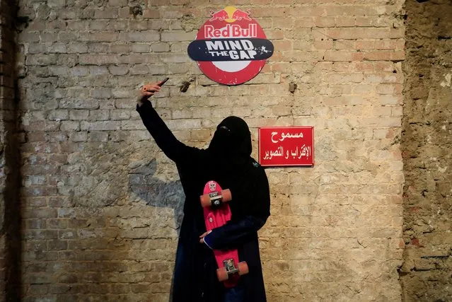Nour Mohamed, 27, an Egyptian woman skateboarder wearing a full veil (niqab), takes a selfie with her board during the Red Bull Mind the Gap first skateboarding event in Egypt, inside Townhouse Gallery near Tahrir Square, amid the coronavirus disease (COVID-19) pandemic in Cairo, Egypt on February 27, 2021. (Photo by Amr Abdallah Dalsh/Reuters)