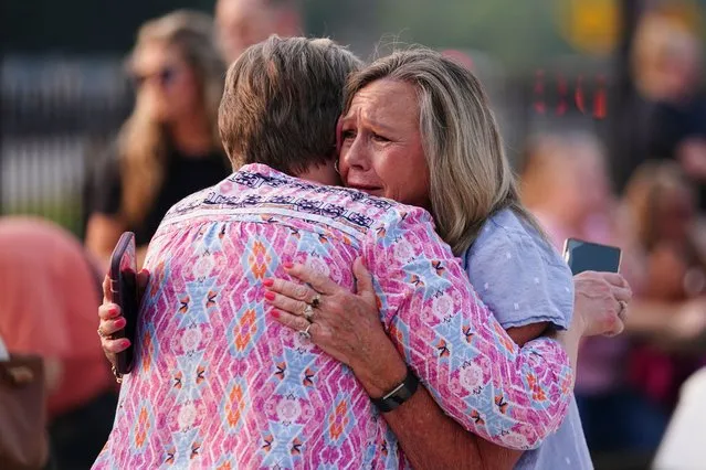 Gaylan Blizzard, right hugs a woman during a vigil for the victims of Saturday's mass shooting on Monday, July 17, 2023, in Hampton, Ga. (Photo by John Bazemore/AP Photo)