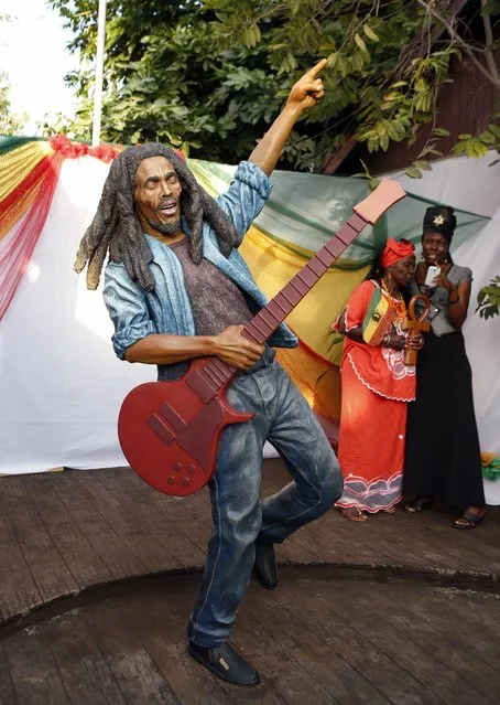 Women take a photograph of a statue of late reggae legend Bob Marley after it was unveiled in Kingston February 8, 2015. (Photo by Gilbert Bellamy/Reuters)