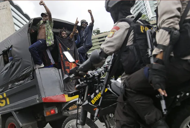 West Papuan protesters shout slogans as they are taken away on a police truck during a rally calling for the remote region's independence, in Jakarta, Indonesia, Thursday, December 1, 2016. (Photo by Dita Alangkara/AP Photo)