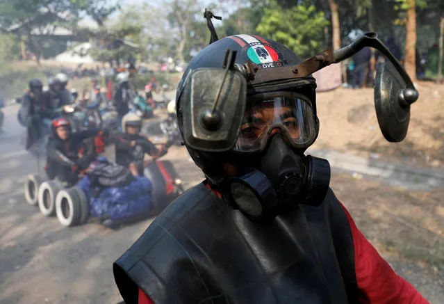 A rider wears a modified helmet and mask while attending a weekend festival for extreme Vespas in Semarang, Central Java, Indonesia, July 22, 2018. (Photo by Darren Whiteside/Reuters)