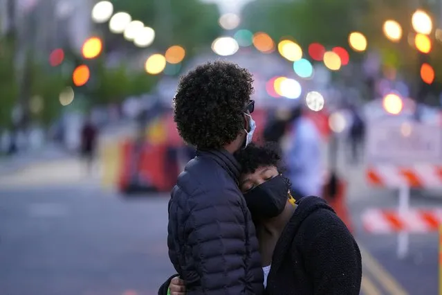 A couple dances at Black Lives Matter Plaza near the White House on Tuesday, April 20, 2021, in Washington, after the verdict in Minneapolis, in the murder trial against former Minneapolis police officer Derek Chauvin was announced. (Photo by Alex Brandon/AP Photo)