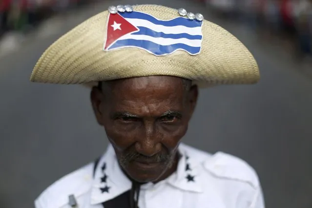 Mario Sala, 73, poses while dressed as a Mambi, who were Cuban independence fighters against Spanish rule in the 19th century, as he waits for the convoy carrying the ashes of former President Fidel Castro to arrive in Palma Soriano, Cuba, December 3, 2016. (Photo by Alexandre Meneghini/Reuters)