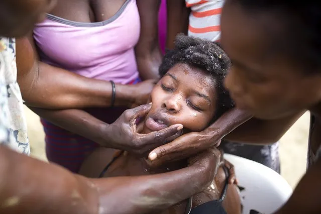 Daphney Joseph is overcome by emotion after an aftershock hit the area and is helped by relatives in Port-de-Paix, Haiti, Sunday, October 7, 2018. A magnitude 5.2 aftershock struck Haiti on Sunday, even as survivors of the previous day's temblor were sifting through the rubble of their cinderblock homes. The death toll stood at 12, with fears it could rise. (Photo by Dieu Nalio Chery/AP Photo)