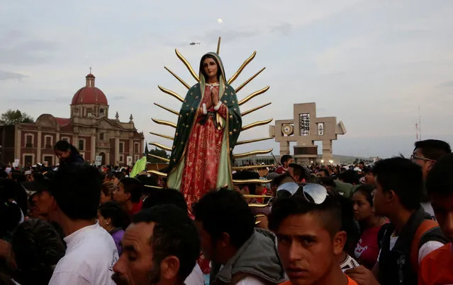 Pilgrims carry a statue of the Virgin of Guadalupe as they arrive at the Basilica of Guadalupe during the annual pilgrimage in honor of the Virgin of Gudalupe, patron saint of Mexican Catholics, in Mexico City, Mexico, December 11, 2016. (Photo by Henry Romero/Reuters)