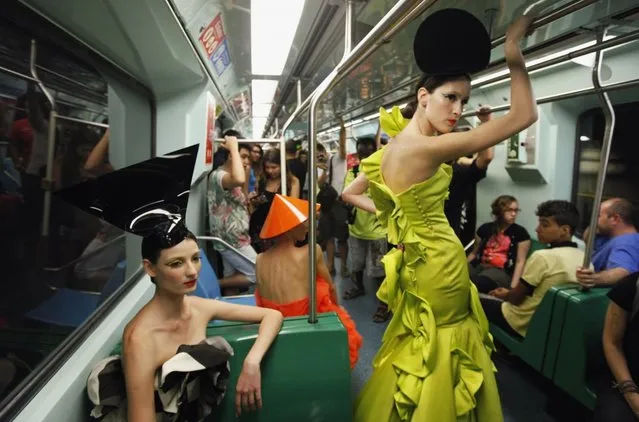 Models present creations in a subway station during Sao Paulo Fashion Week in Sao Paulo October 27, 2013. (Photo by Paulo Whitaker/Reuters)