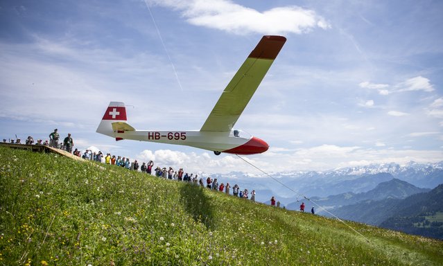 A sailplane K8 during the start from the Rigi mountain at Rigi-Kulm above the Lake of Lucerne, Switzerland, 27 June 2021. Eleven historical sailplanes, mostly from the fourties and fifties, were airborne with the help of an elastic band during the weekend. (Photo by Urs Flueeler/EPA/EFE)