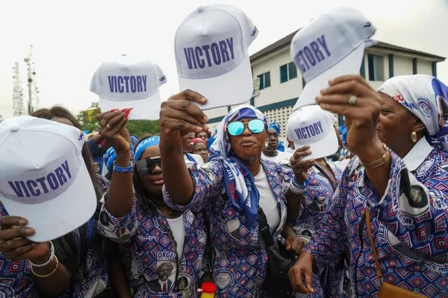 Supporters of the leader of Liberia's ruling party Coalition for Democratic Change (CDC), President and former soccer player George Weah, holds their caps as they attend to his final campaign rally for the presidential elections in Monrovia, Liberia on October 8, 2023. (Photo by Carielle Doe/Reuters)