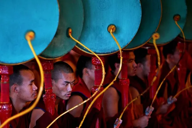 Buddhist monks play drums during morning prayers at Gyuto Monastery in Dharamsala on October 11, 2023. (Photo by Arun Sankar/AFP Photo)