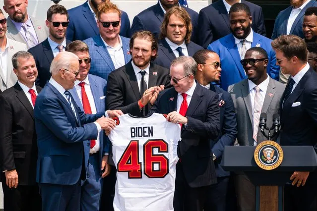 Owner of The Tampa Bay Buccaneers Bryan Glazer presents US President Joe Biden a team jersey during a celebration of the Tampa Bay Buccaneers Super Bowl victory on the South Lawn at the White House on July 20, 2021. (Photo by Demetrius Freeman/The Washington Post)