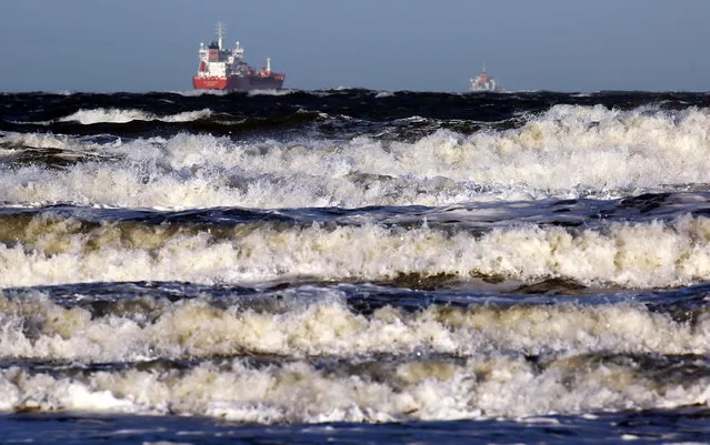 Ferries navigate through big waves on the Baltic Sea near Warnemeunde, northeastern Germany, on January 4, 2017. Meteorologists issued storm tide warnings for the region. (Photo by Bernd Wüstneck/AFP Photo/DPA)