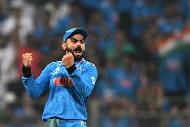 India's Virat Kohli celebrates after the dismissal of New Zealand's Daryl Mitchell during the 2023 ICC Men's Cricket World Cup one-day international (ODI) first semi-final match between India and New Zealand at the Wankhede Stadium in Mumbai on November 15, 2023. (Photo by Punit Paranjpe/AFP Photo)