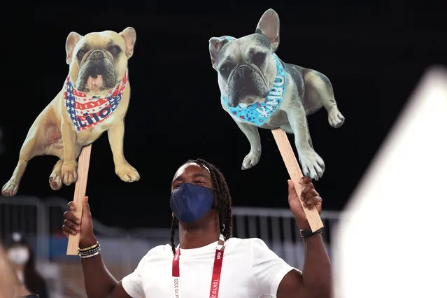 A member of the crowd holds signs with dogs during the Women's Balance Beam Final on day eleven of the Tokyo 2020 Olympic Games at Ariake Gymnastics Centre on August 03, 2021 in Tokyo, Japan. (Photo by Laurence Griffiths/Getty Images)