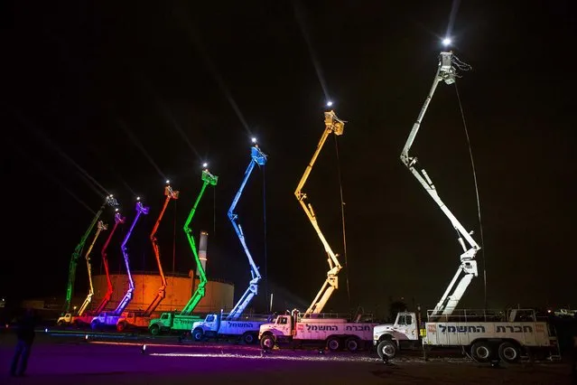 The lights are turned on for a giant menorah at the Reading Power Station in Tel Aviv, on the Jewish holiday of Hanukkah, on December 4, 2013. Israel's electric company said it had created the world's largest menorah, consisting of nine aerial platforms reaching 28 meters and lit with nine white light beams reaching the height of ten kilometers. Hanukkah, also known as the Festival of Lights, came to an end on Wednesday. (Photo by Nir Elias/Reuters)