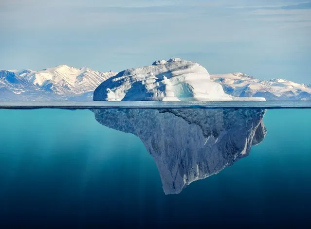 Iceberg with above and underwater view. (Photo by the-lightwriter/Getty Images)