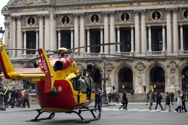 A rescue helicopter stands ready to evacuate wounded people in front of the Paris Opera House following a gas leak explosion, France, Saturday, January 12, 2019. A powerful explosion and fire apparently caused by a gas leak at a Paris bakery Saturday injured several people, blasted out windows and overturned cars, police said. (Photo by Thibault Camus/AP Photo)