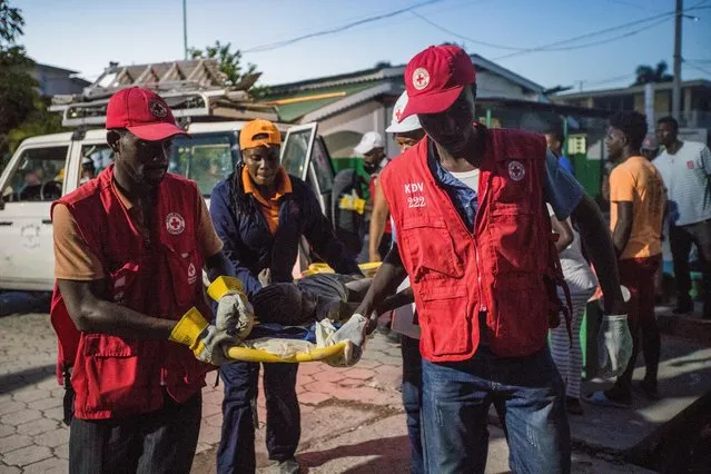 Red Cross paramedics carry a girl injured during a 7.2 magnitude earthquake in Les Cayes, Haiti on August 14, 2021. (Photo by Ralph Tedy Erol/Reuters)