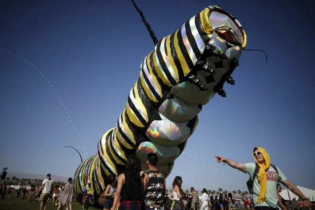 A man walks past an artwork called “Papilio Merraculous” by Poetic Kinetics at the Coachella Valley Music and Arts Festival in Indio, California April 11, 2015. (Photo by Lucy Nicholson/Reuters)