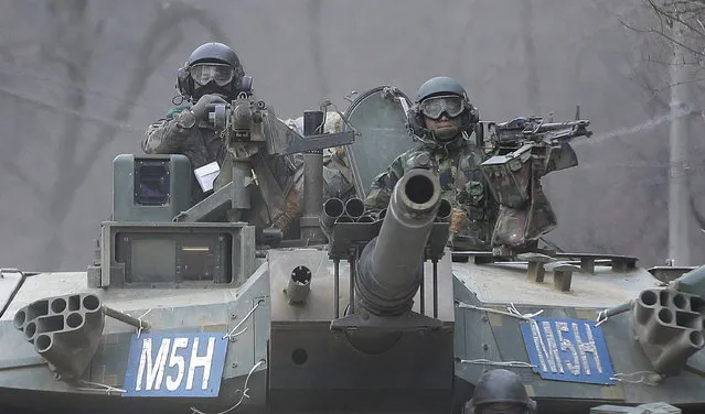 South Korean army soldiers ride a K-1 tank during the annual exercise in Paju, near the border with North Korea, Friday, February 19, 2016. North Korean leader Kim Jong Un recently ordered preparations for launching “terror” attacks on South Koreans, a top Seoul official said Thursday, as worries about the North grew after its recent nuclear test and rocket launch. (Photo by Ahn Young-joon/AP Photo)