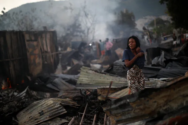 A woman reacts after a fire burnt several businesses in a street of Port-au-Prince, Haiti on December 16, 2018. (Photo by Andres Martinez Casares/Reuters)