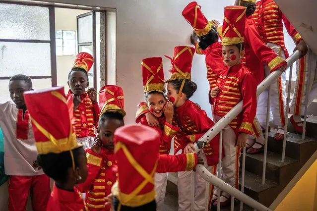Students of the Dance Centre Kenya (DCK) react while waiting to take the stage during the production of the “Nutcracker”, a classical ballet traditionally performed in the Christmas period, at the Kenya National Theatre in Nairobi on November 26, 2023. (Photo by  Luis Tato/AFP Photo)