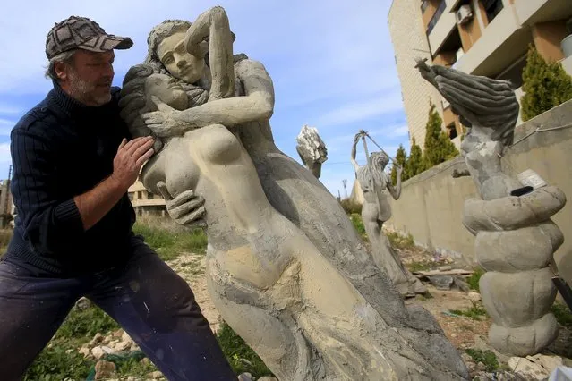 Ukrainian artist Sergey Boyatzi, 56, works on his sculpture in the village of Baqsta, Sidon district, southern Lebanon January 29, 2016. Boyatzi, who lives in Lebanon, is seeking to transform a southern Lebanon village into an open-air museum which blends art with its surroundings. (Photo by Ali Hashisho/Reuters)