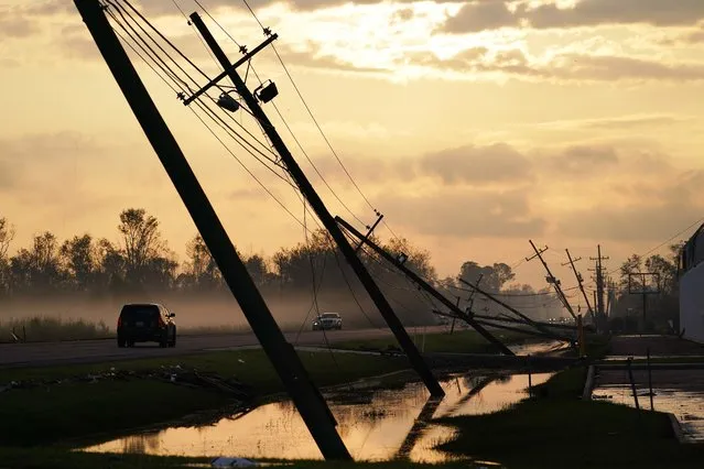 Downed power lines slump over a road in the aftermath of Hurricane Ida, Friday, September 3, 2021, in Reserve, La. (Photo by Matt Slocum/AP Photo)