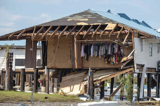 A house is seen in the aftermath of Hurricane Ida in Grand Isle, La. Tuesday, August 31, 2021. Louisiana residents still reeling from flooding and damage caused by Hurricane Ida scrambled for food, gas, water and relief from the sweltering heat while facing the dispiriting prospect of weeks without electricity to power air conditioners and refrigerators. (Photo by Scott Clause/The Daily Advertiser via AP Photo)