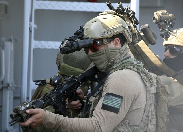 A U.S. Navy SEAL special forces operator, front, and colleagues during a joint U.S.-Cyprus military drill at Limassol port on Friday, September 10, 2021. Cyprus' Defense Minister Charalambos Petrides said the U.S. and Cyprus are on the same strategic path to ensure security and stability in a turbulent region and that continued close cooperation between the special forces of both countries aim to counter threats from potential terrorist acts. (Photo by Philippos Christou/AP Photo)