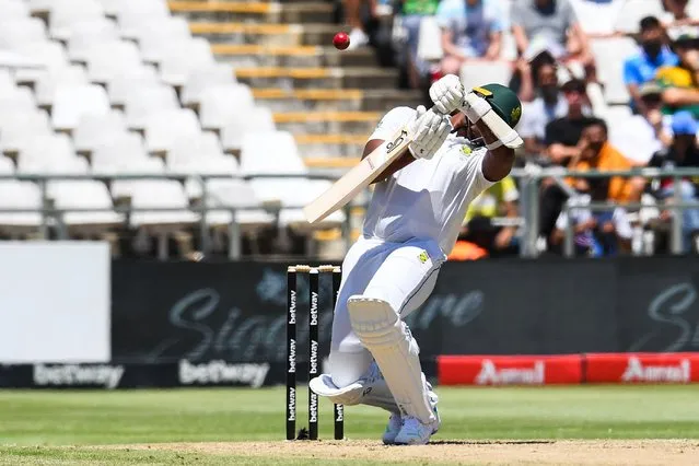 South Africa's Lungi Ngidi reacts after being hit by a ball delivered by India's Prasidh Krishna (unseen) during the second day of the second cricket Test match between South Africa and India at Newlands stadium in Cape Town on January 4, 2024. (Photo by Rodger Bosch/AFP Photo)