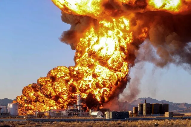 A general view of fire at an oil refinery in Birjand, Iran on December 10, 2023. Despite two explosions, there have been no reported injuries. All 18 reservoirs at the refinery are said to have caught fire, while the initial stages of the blaze “consumed 1.5 million litres of fuel”, the news agency Fars said. (Photo by Mohsen Noferesti/IRNA/WANA (West Asia News Agency) via Reuters)