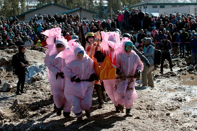 Team Cracklin Bacon of Boulder, Colorado, races during the Frozen Dead Guy Days festival's Coffin Races on March 9, 2019 in Nederland, Colorado. Frozen Dead Guy Days honors Bredo Morstol, who is frozen in a state of suspended animation and housed in a Tuff Shed in the hills above the town. Events such as coffin races, ice turkey bowling, and a frozen t-shirt contest attract visitors to the two day festival each year. (Photo by Jason Connolly/AFP Photo)